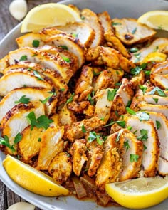 sliced chicken with lemons and parsley in a bowl