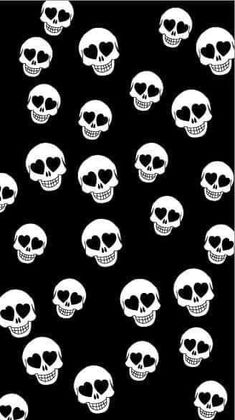 a lot of white skulls with hearts on black background stock photo - 1387982