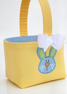 a yellow bag with a blue bunny on the front and white polka dots around it