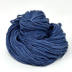 a ball of blue yarn sitting on top of a white surface