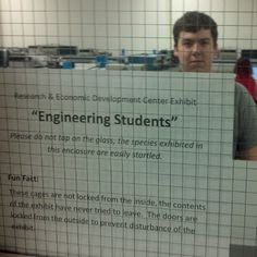 a man holding up a sign that says engineering students