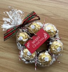 chocolates wrapped in cellophane and tied with red ribbon on wooden table top