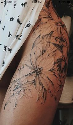 a woman's thigh with flowers on it