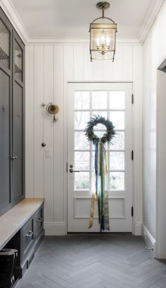 a door with a wreath hanging from it's side