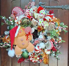 a christmas wreath with candy canes, candies and a gingerbread