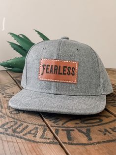 "FEARLESS kids baby/toddler and Kids size Snapback hat. Stylish, durable and high quality for your adventurous little one! Adjustable Snapback style so it will fit them as they grow. Available in Heather Gray, Black or Gray Camo. Features: * Adjustable Snapback style to grow with your child * Stylish and high quality * Faux leather patch * Hand sewn * Ready to ship! * Comfortable and breathable so your kids will love to wear them! Sizing: *On average our hats will fit the age ranges specified be Casual Trucker Hat With Flat Brim For Adventure, Casual Flat Brim Snapback Hat For Adventure, Casual Trucker Hat With Flat Bill For Adventure, Casual Flat Brim Trucker Hat For Adventure, Casual Flat Bill Trucker Hat For Adventure, Adjustable Casual Snapback Hat With Leather Patch, Casual Baseball Cap With Flat Bill For Adventure, Casual Snapback Baseball Cap For Adventure, Casual Snapback Hat For Adventure