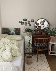 a bedroom with a bed, desk and mirror