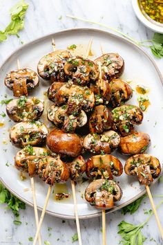 chicken and mushroom skewers on a white plate