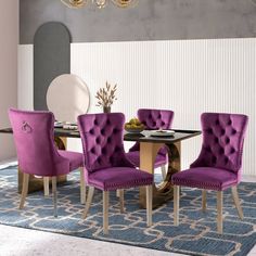 a dining room with purple chairs and a chandelier