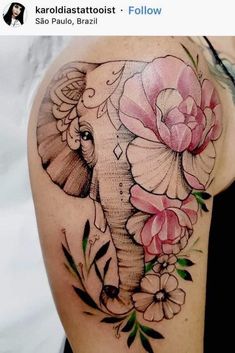 an elephant with flowers on it's back shoulder and chest is shown in this tattoo design