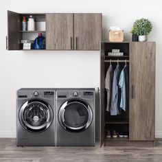 a washer and dryer sitting next to each other in front of a cabinet