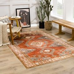 a living room filled with furniture and a large rug