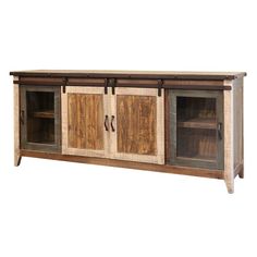 an entertainment center with sliding doors and drawers