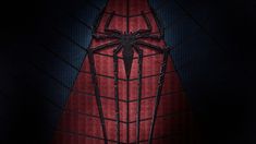 the amazing spider - man movie poster is shown in black and red colors, with an intricate web design on it's side