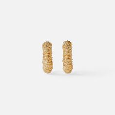 The Paola Sighinolfi Amulet Earrings stand out for their personality and character. These handmade textured mini hoops are sure to be your new go to's 18k Gold Plated 2cm Made in Spain Earrings Stand, Earring Stand, 18k Gold, Gold Plate, Spain, Plating, Gold