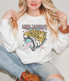 Add this Wild Spirit sweatshirt to your trendy wardrobe this season. This preppy sweater is slightly distressed and oversized with a rock and roll aesthetic. * Ultra soft * Distressed design * Pre-shrunk * Universal fit * True to size * DTG Printing * Brand - Gildan Refunds/Exchanges: * No Cancellations * No returns/exchanges * All sales are final Sizing: Our graphic tees and sweatshirts are a true to size standard unisex fit. For an oversized look, please size up. For a TShirt dress fit, we recommend sizing up at least two sizes. Please oversee the sizing chart provided in the listing photos to ensure your measurements are correct as we DO NOT offer cancellations, exchanges or returns. Shipping: All products are made to order and are usually ready to ship within 2-7 business days. Please White Punk Cotton Sweatshirt, White Cotton Punk Sweatshirt, White Cotton Punk Style Sweatshirt, Edgy White Tops For Winter, Edgy White Winter Top, White Punk Tops For Fall, White Punk Sweatshirt For Winter, Edgy White Sweatshirt For Streetwear, Edgy White Winter Sweatshirt