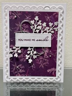 a purple card with white flowers on it, and the words you make me smile