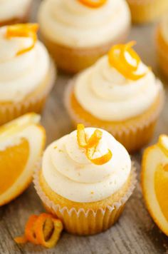 cupcakes with white frosting and orange slices