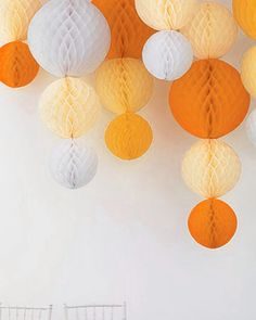 white and orange paper lanterns hanging from the ceiling