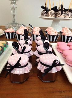 cupcakes and cookies are arranged on the table