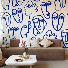 a living room filled with furniture and wallpaper covered in blue faces