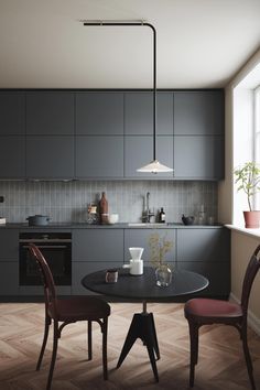 a kitchen with a table and chairs in it