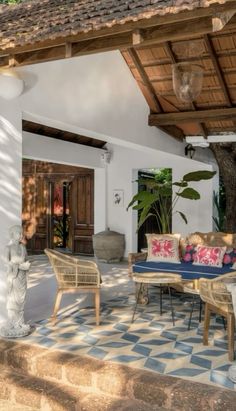 an outdoor living area with furniture and potted plants