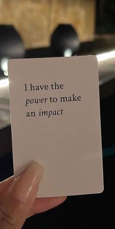 someone holding up a card that says, i have the power to make an impact