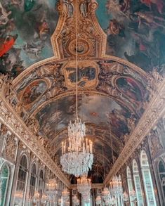 an ornate room with chandeliers and paintings on the ceiling