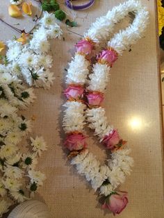 white and pink flowers are laid out on a table