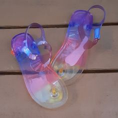 New! These Jellies Are Beautiful! They Have An Ombre Effect Starting With Yellow And Ending In Purple. Velcro Strap Makes Them Easy To Put On And Take Off! Grab Them Today! Playful Synthetic Jelly Sandals For Summer, Playful Plastic Sandals For Summer, Playful Adjustable Jelly Sandals For Summer, Adjustable Playful Jelly Sandals For Summer, Playful Jelly Sandals For Summer, Playful Jelly Sandals For Summer Beach, Playful Jelly Sandals For Beach In Summer, Fun Plastic Sandals For Summer, Playful Plastic Jelly Sandals For Summer