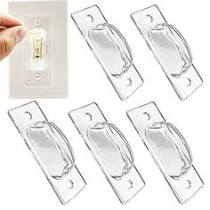 four clear glass door handles and one light switch