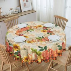 a dining room table set with plates and placemats on top of the table