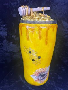 a yellow vase with some honey in it