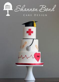 a three tiered cake decorated with medical symbols and heart on it's side