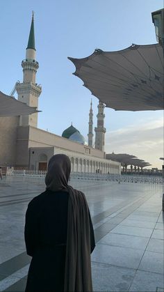 a person standing in front of a large building