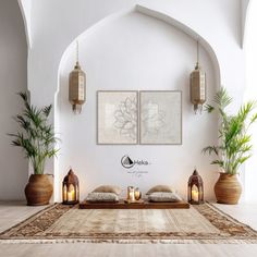 a living room filled with lots of furniture next to two potted plants and candles