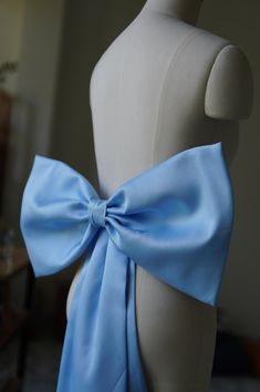 a mannequin with a blue bow on it's back