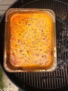 a casserole is cooking on an outdoor grill