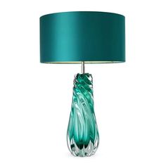 a table lamp with a green shade on it's base and a white background