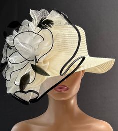 The featured hat is an ivory straw hat with a lovely crinoline design in white, black and ivory. A large ivory crinoline disc trimmed in black sits at the side of the hat. In its center is a white large  flower also trimmed in black. This organza flower is made of large white petals.  This hat will be perfect for Church or for the Kentucky Derby.  It's also perfect as a Tea Party Hat, Easter Hat, Wedding Party hat, Garden Party Hat and any  special  occasion. Brim: 3" Rise: 3.75" Size:  Internal draw string to adjust size Cream Flat Brim Straw Hat For Garden Party, Cream Boater Hat With Flat Brim For Garden Party, White Straw Hat With Short Brim For Country Events, Cream Fascinator With Short Brim For Garden Party, Chic Cream Straw Hat For Kentucky Derby, Elegant White Fedora Straw Hat, Cream Fascinator Hat For Garden Party, White Curved Brim Straw Hat For Country Events, Chic Cream Sun Hat For Kentucky Derby