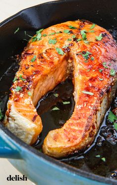 the fish is being cooked in the skillet on the stove top and ready to be eaten