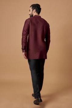 Maroon cotton silk full sleeve shirt kurta with pintuck detailing on neckline.
Components: 1
Type Of Work: Plain
Neckline: Mandarin collar
Sleeve Type: Full sleeves
Fabric: Cotton Silk
Color: Maroon
Other Details: 
Front button detailing
Cuff sleeve hem
Model height: 5ft 10inches, wearing size M
Note: Pant worn by the model is not for sale
Occasion: Mehendi and Puja - Aza Fashions Long Sleeve Cotton Bandhgala For Eid, Formal Cotton Nehru Jacket With Long Sleeves, Cotton Kurta For Work With Long Sleeves, Elegant Cotton Bandhgala With Long Sleeves, Formal Long Sleeve Cotton Nehru Jacket, Traditional Long Sleeve Nehru Jacket For Workwear, Cotton Nehru Jacket With Long Sleeves For Eid, Long Sleeve Cotton Nehru Jacket For Eid, Festive Long Sleeve Nehru Jacket For Work