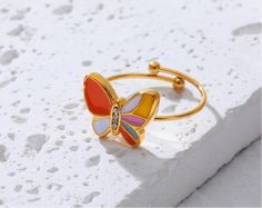 Creative Cute Colorful Enamel Mini Butterfly Rings - Stainless Steel 18K Gold Plated Waterproof Jewelry for Women & Girls Discover the charm of the Creative Cute Colorful Enamel Mini Butterfly Rings, designed to add a playful touch to any jewelry collection. Crafted from high-quality stainless steel and plated with 18K gold, these rings offer both durability and a luxurious finish. The vibrant enamel butterflies bring a burst of color, making these rings a delightful addition to your accessory w Yellow Enamel Ring, Gold Enamel Ring Perfect For Gifting, Gold Enamel Ring For A Gift, Gold Enamel Ring Perfect For Gift, Multicolor Enamel Ring As Gift, Multicolor Enamel Ring For Gift, Adjustable Multicolor Enamel Rings, Multicolor Hypoallergenic Rings For Gifts, Adjustable Gold Enamel Ring