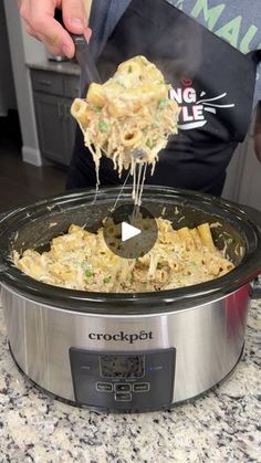 a person is scooping food out of the crock pot