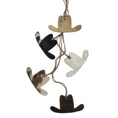 an assortment of toy animals hanging from strings on a white background, with one animal wearing a cowboy hat