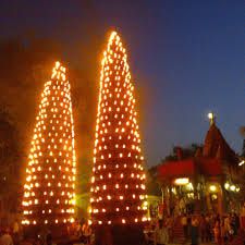 three lighted trees in the middle of a park