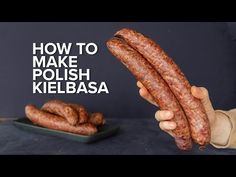 a person holding two sausages in front of a plate with the words how to make polish kielbasa