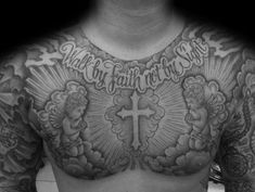 a man's chest with tattoos and words on it