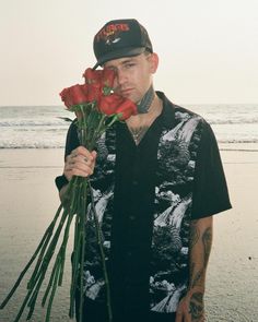 a man holding roses in front of his face